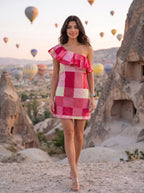 Pink Colorblock One-Shoulder Ruffle Mini Dress - Seated with champagne on trunk